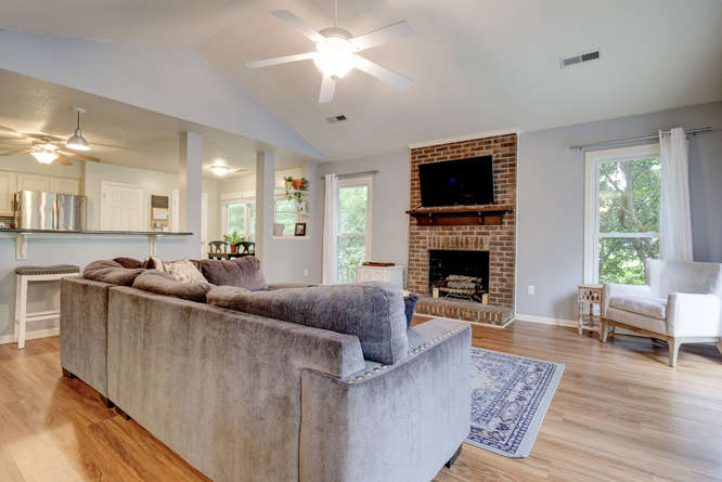 picture of living room with fireplace and large kitchen